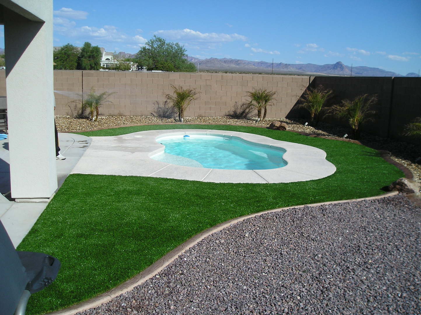 Artificial turf surrounding a backyard pool